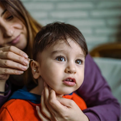little boy receiving ear drops